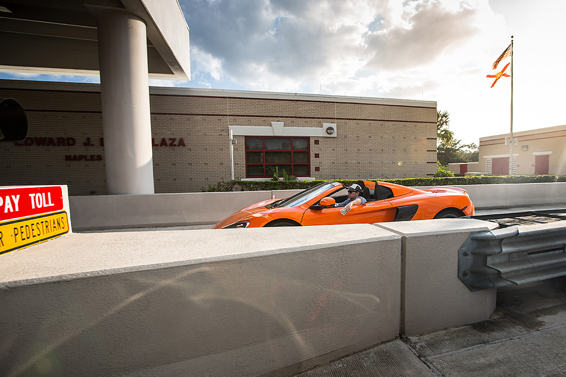 Flashing $2 out the window of a $352,000 McLaren